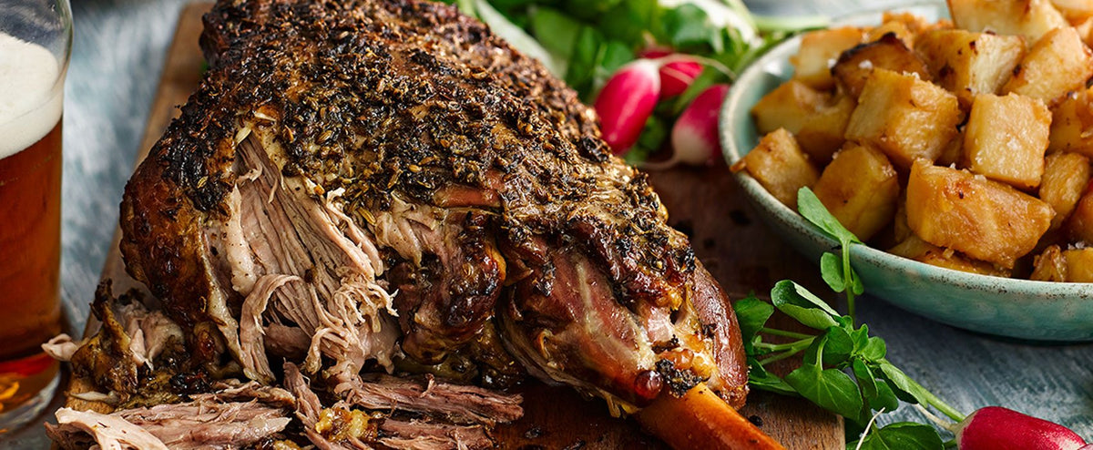 Badger beer slow roast lamb served on a platter with radishes and roast potatoes