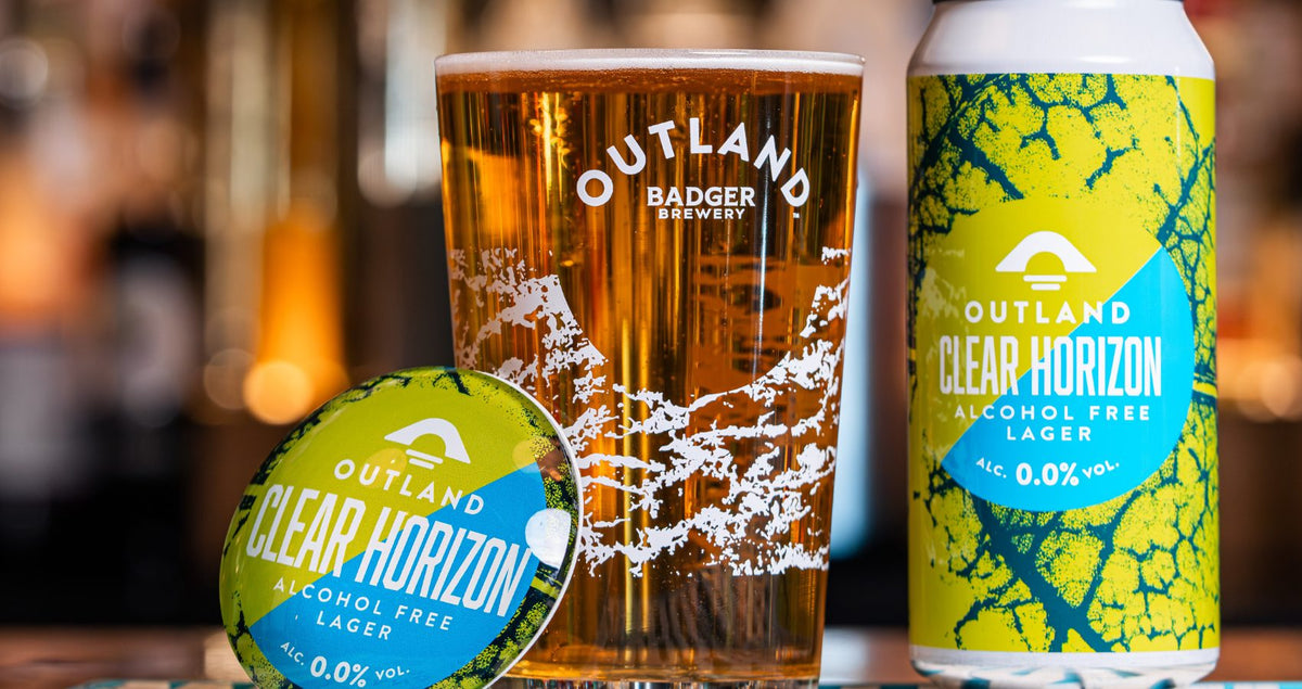 Outland Clear Horizon can, pint glass and pump clip lined up together