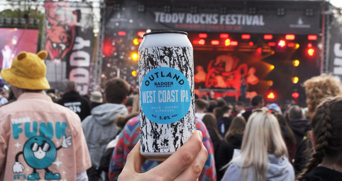 Can of Outland West Coast IPA held up in the crowd at Teddy Rocks Festival