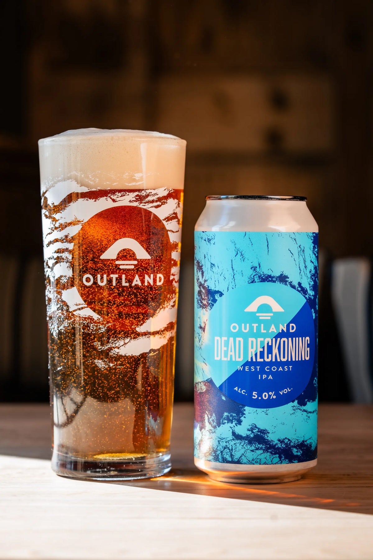 Outland pint and a can of Dead Reckoning on a pub table
