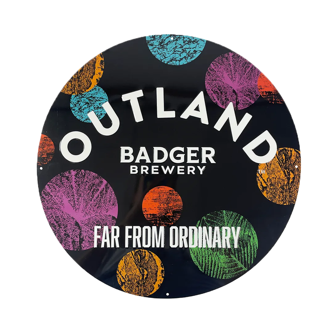 Round Outland tin sign with a Far From Ordinary strapline and coloured circle artwork