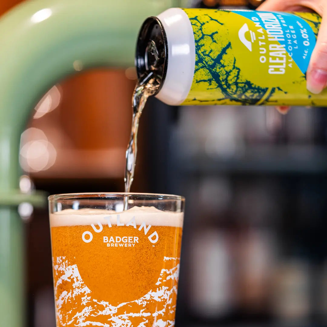 Outland Clear Horizon poured from the can into an Outland branded pint glass