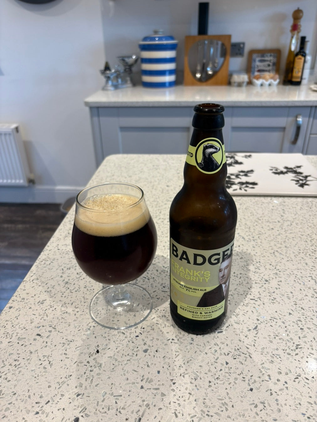 Bottle of Badger stout and a stemmed glass on a kitchen worktop