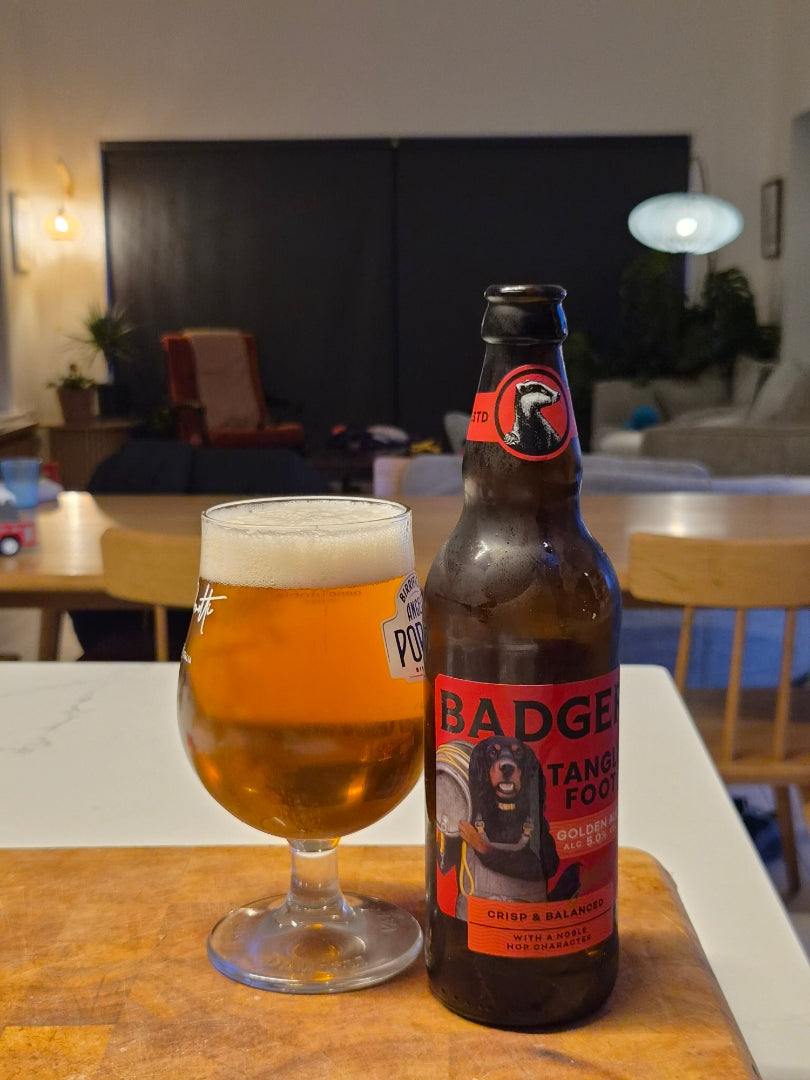 Bottle of Badger Iron Hart and a full pint on a table in a modern kitchen
