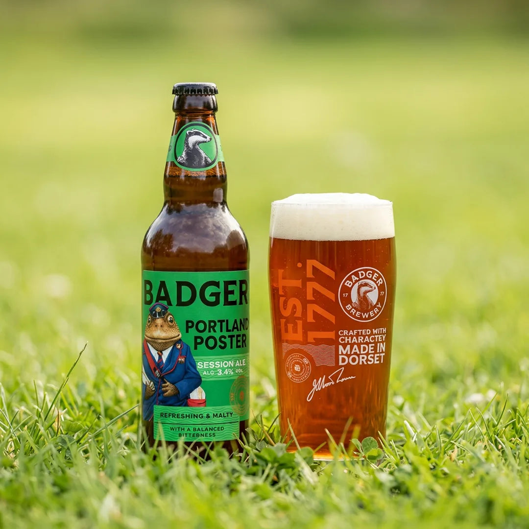 Bottle of Badger Portland Poster and a full pint glass standing on grass