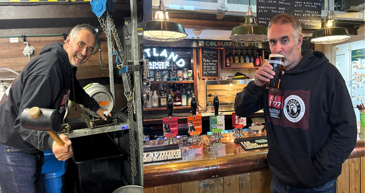 Badger head brewer Toby Heasman tapping a cask of ale at the bar
