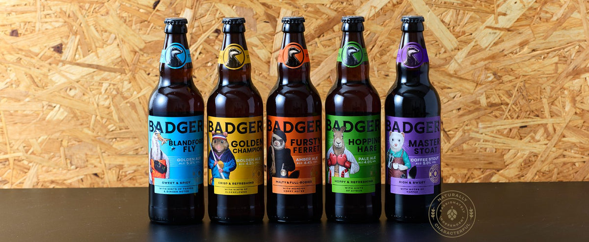 Line-up of five bottles from the revitalised Badger beer range against a plywood wall