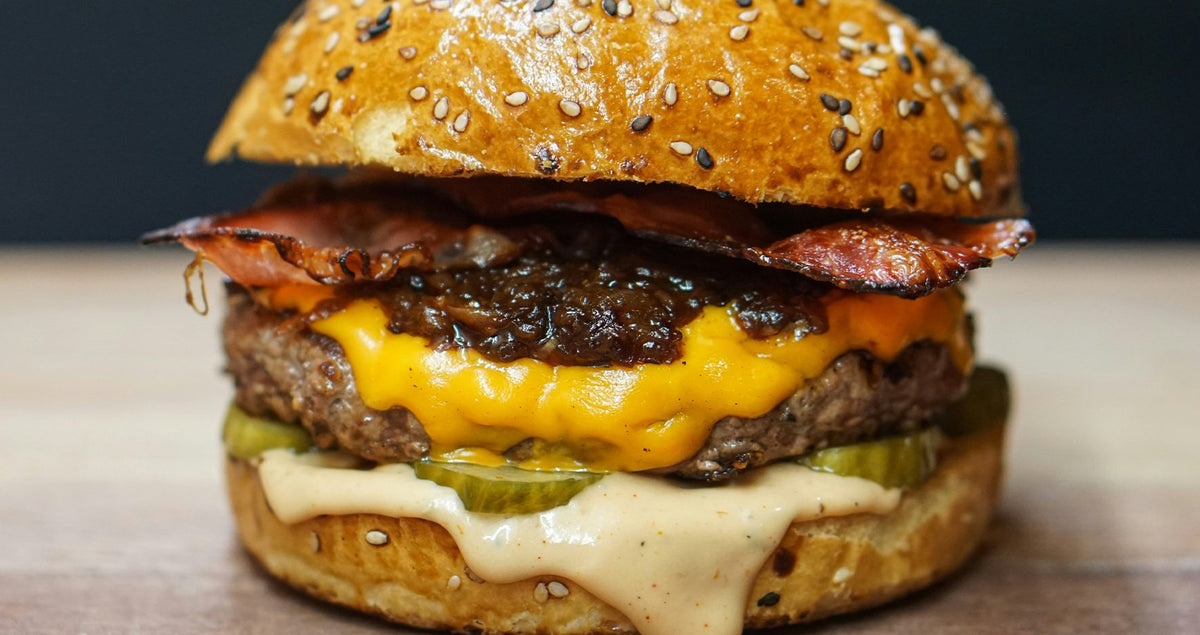 Cheeseburger with melted cheese and bacon, paired with Badger ale