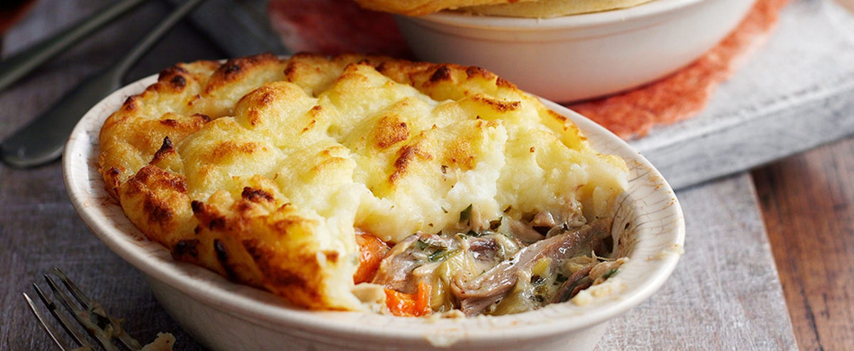 Guinea fowl pot pie with a piped mashed potato topping, part-served