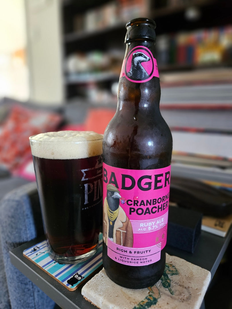 Bottle of Badger Cranborne Poacher and a dark pint on a pub table