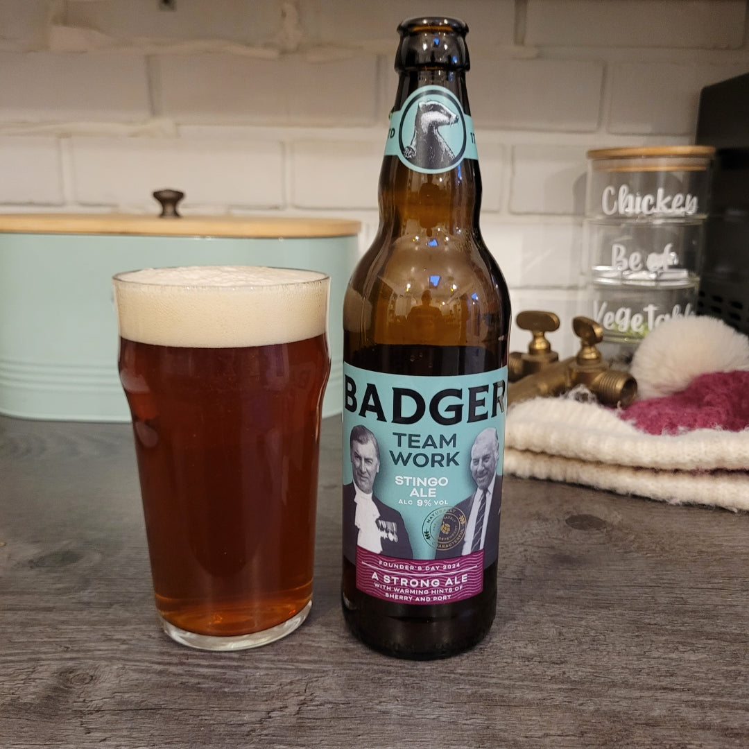 Bottle of Badger Teamwork and a full pint glass on a kitchen worktop