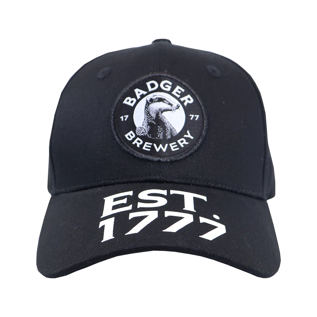 Black Badger Brewery baseball cap, front view, with the badger roundel logo above an Est. 1777 peak