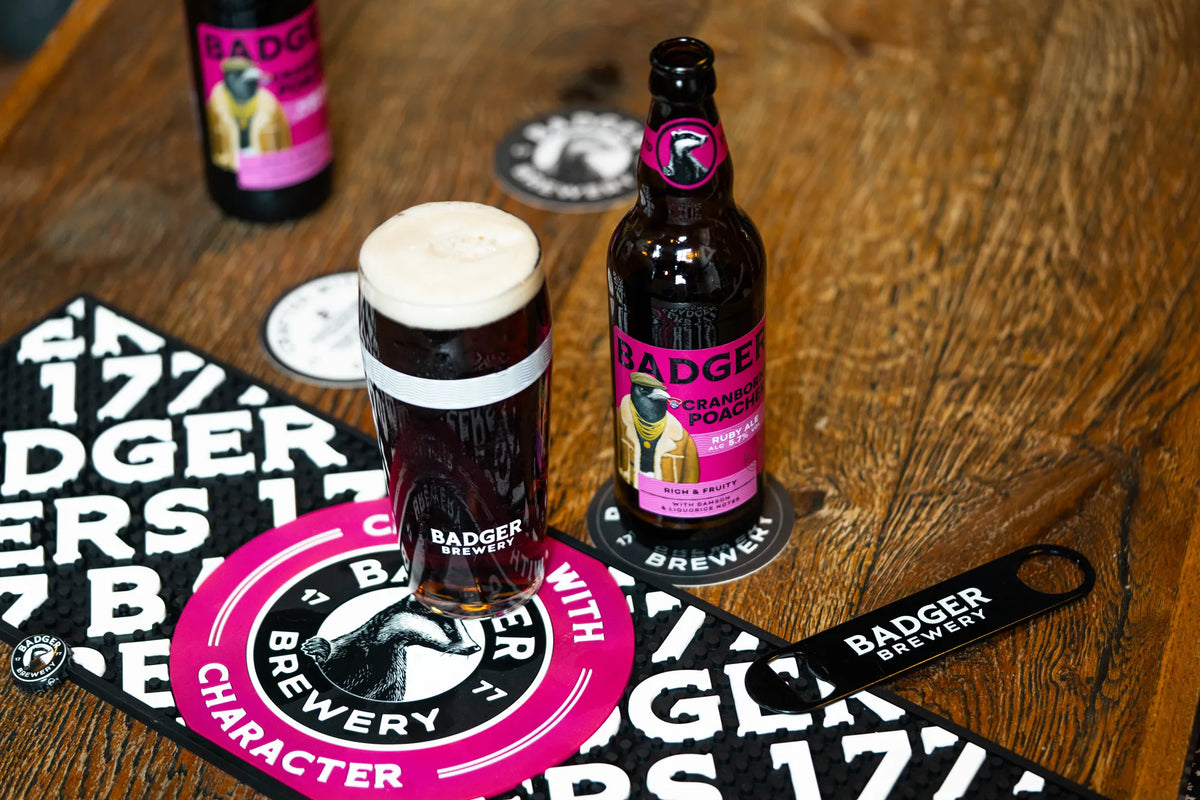Bottle and half pint of Cranborne Poacher on a wooden table with a Badger bar runner
