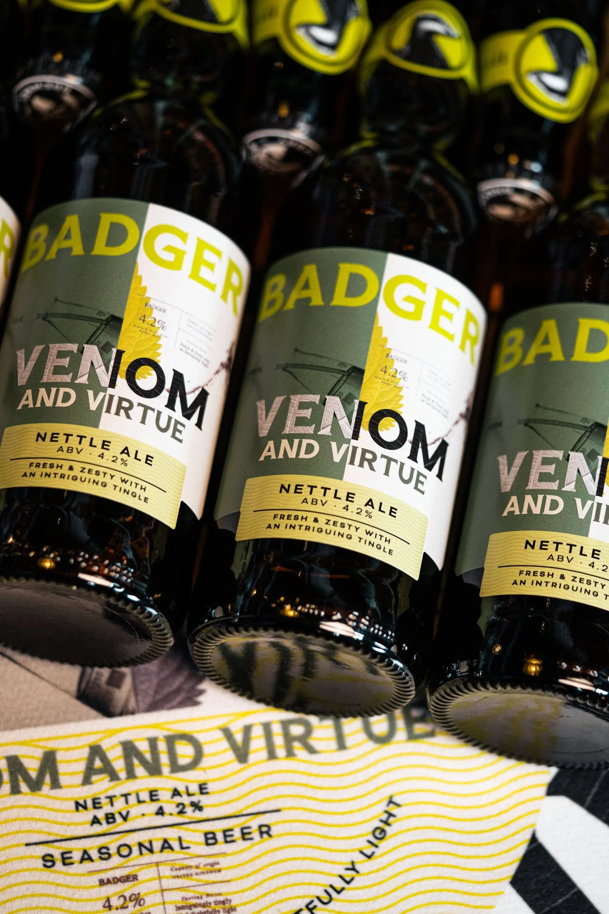 Bottles of Badger Venom and Virtue laid out flat with the seasonal beer label facing up