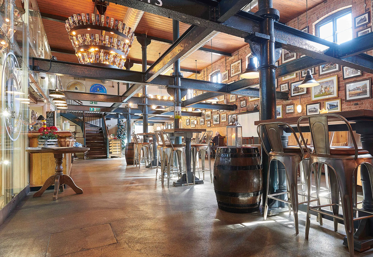 Interior of the Badger Brewery Tap bar with barrels and high tables