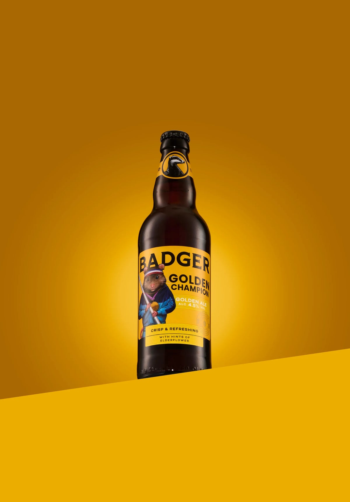 Bottle of Badger Golden Champion golden ale on a yellow background
