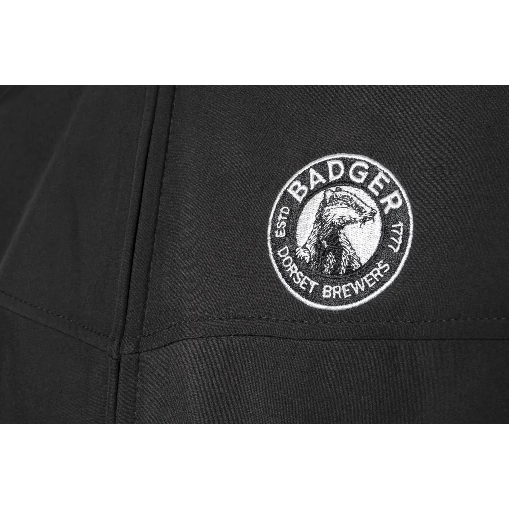 Close-up of the embroidered Badger Brewery roundel on the chest of the black Badger jacket