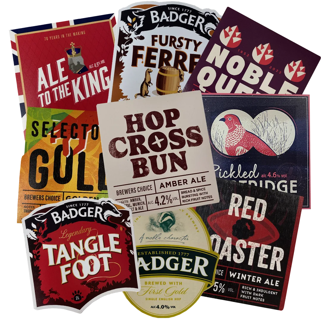 Assortment of Badger beer pump clips including Tangle Foot, Fursty Ferret and Hop Cross Bun