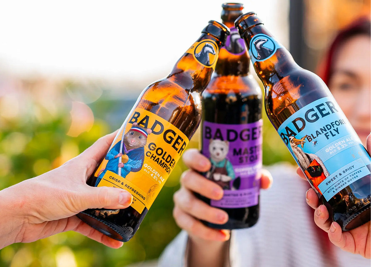 Hands holding up a fan of Badger bottles from the range