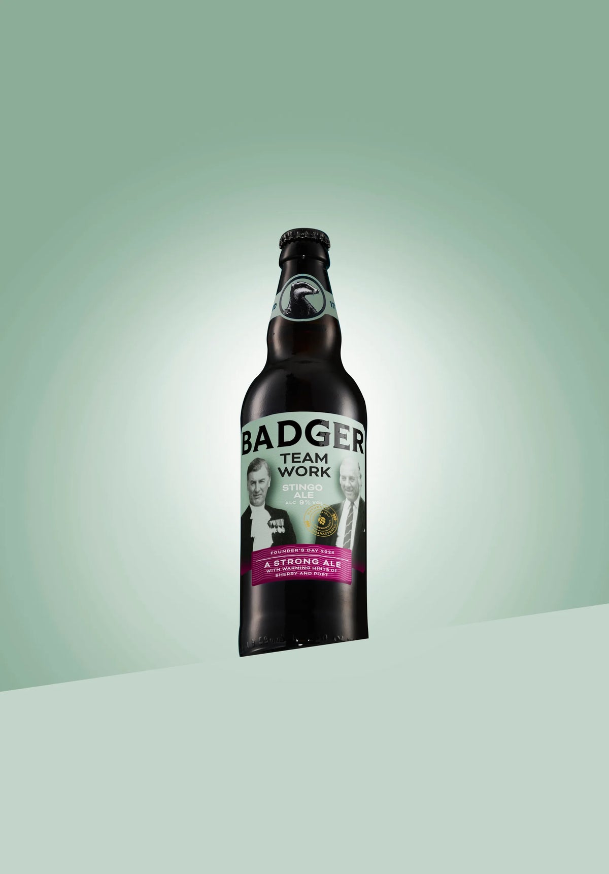 Bottle of Badger Teamwork stingo ale on a pale green background