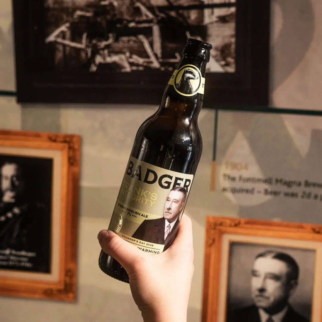 Bottle of Badger Frank's Integrity held up in the brewery's Magna Brewery heritage display