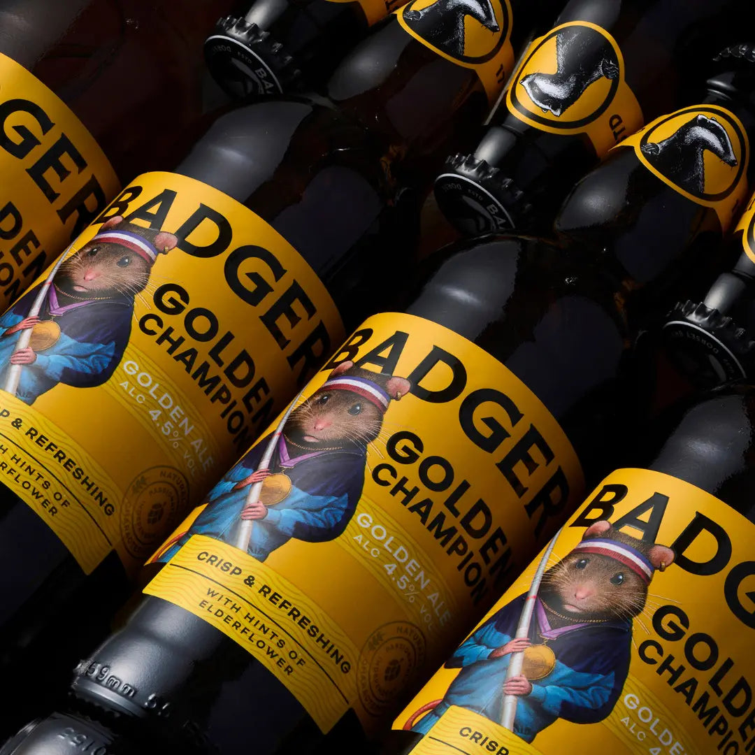 Rows of Badger Golden Champion bottles laid out on a dark surface