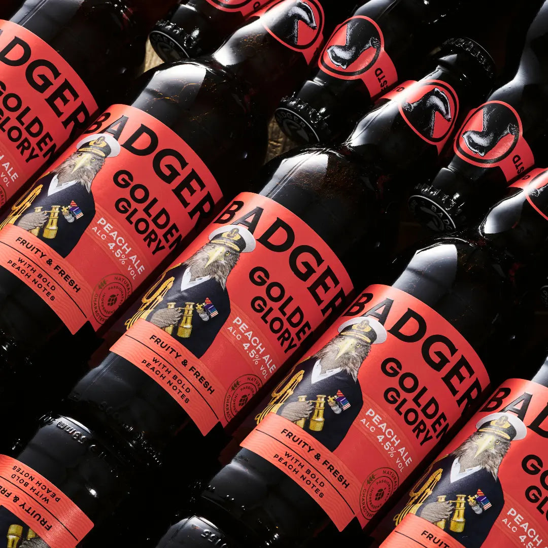 Rows of Badger Golden Glory bottles laid out on a dark surface