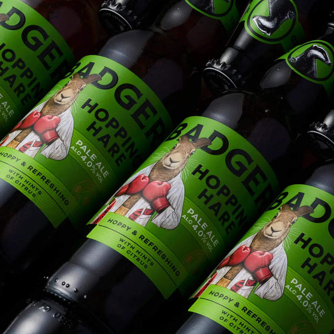 Rows of Badger Hopping Hare bottles laid out on a dark surface