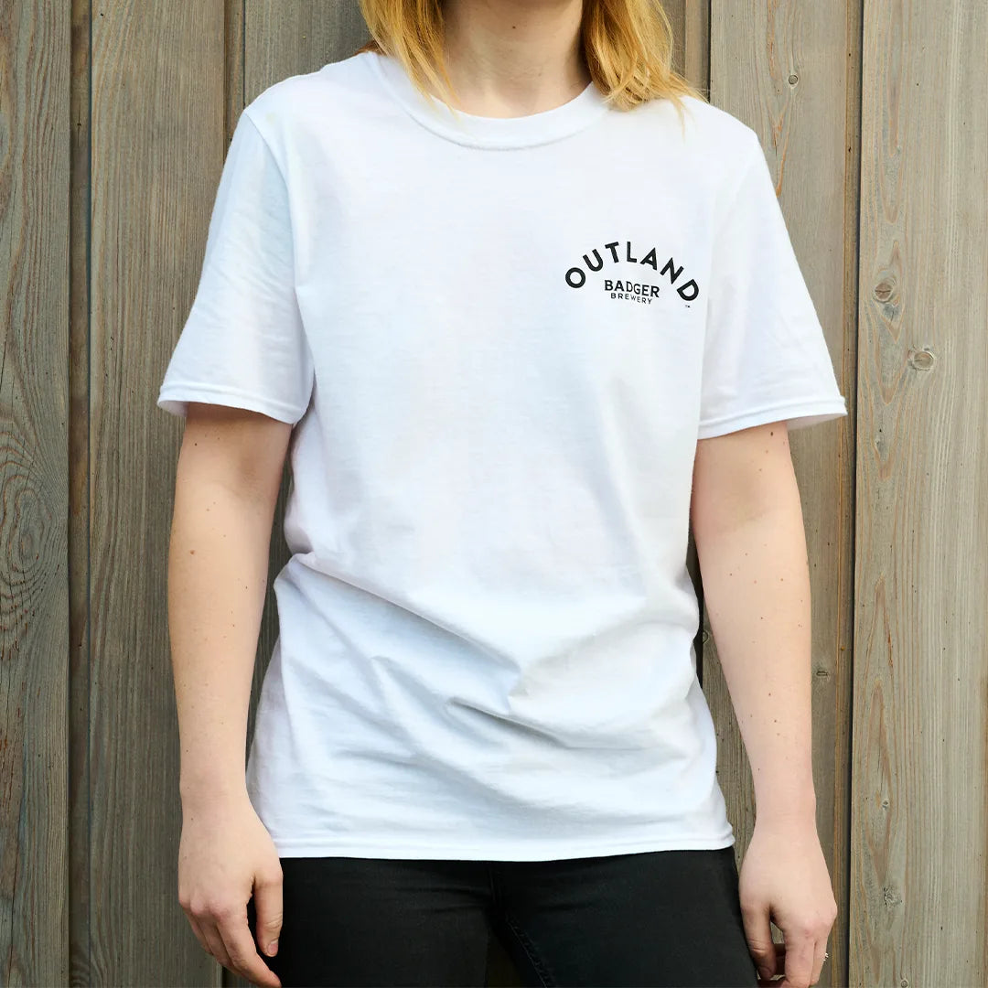 Woman wearing the white Outland t-shirt, front view with a small chest logo
