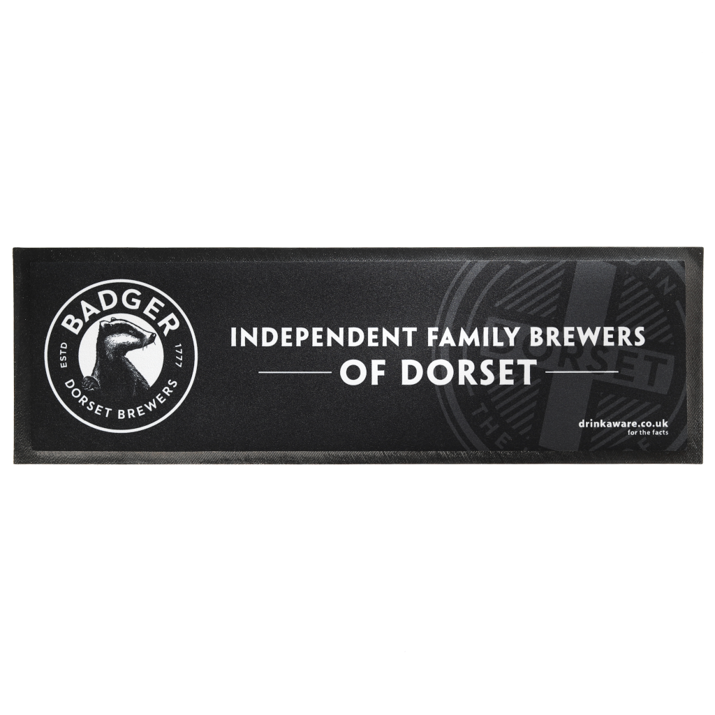 Full overhead view of Badger Beers bar runner item of merchandise with logo and slogan saying Independent Family Brewers of Dorset