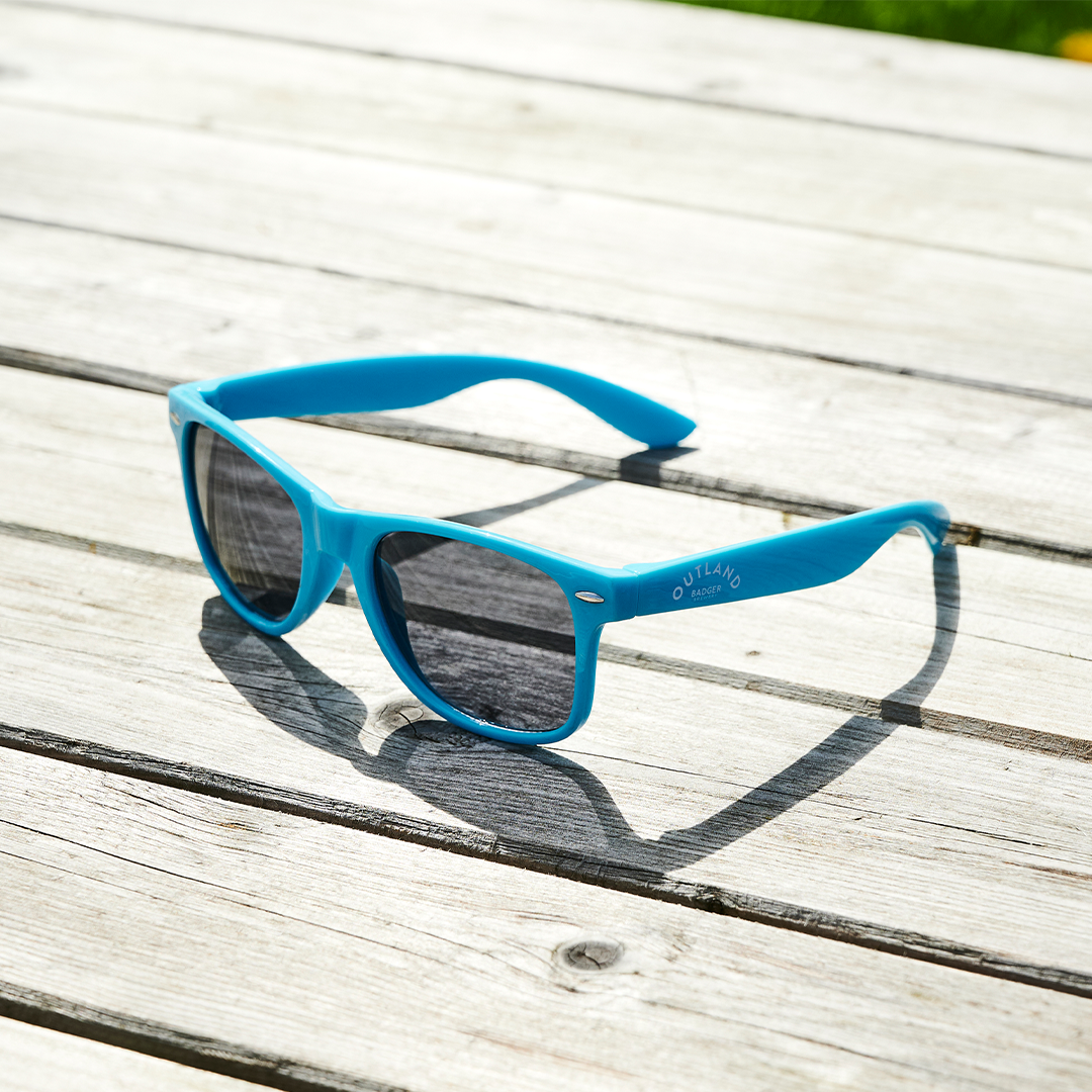 Outland Blue Sunglasses on table (side)