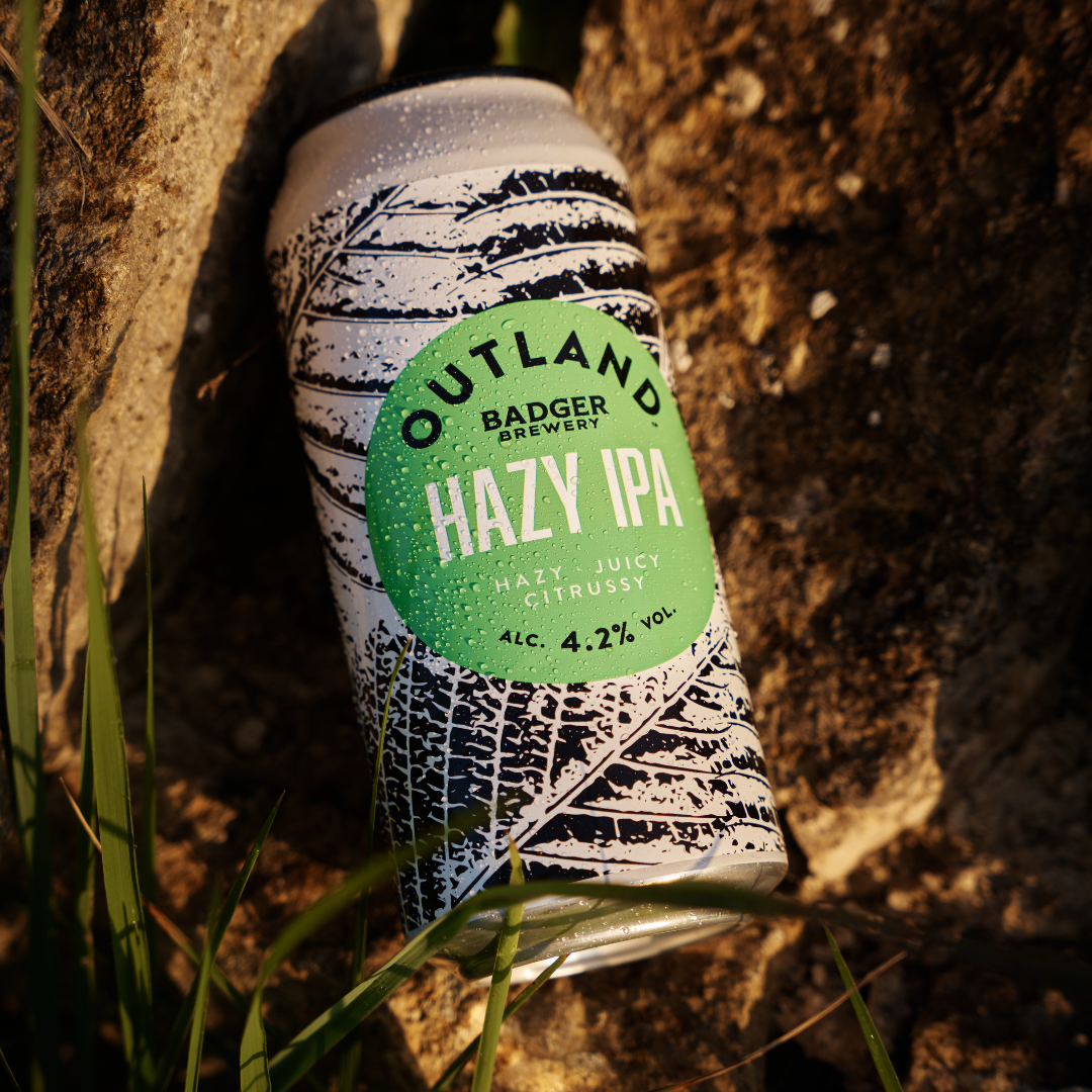 Outland Hazy IPA can against tree