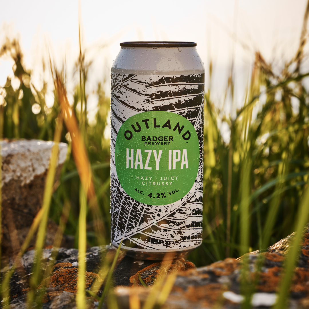 Outland Hazy IPA can in grass