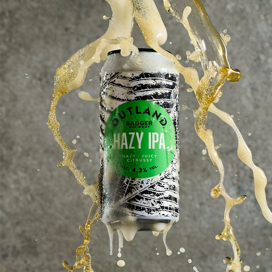 Outland Hazy IPA can with liquid splash