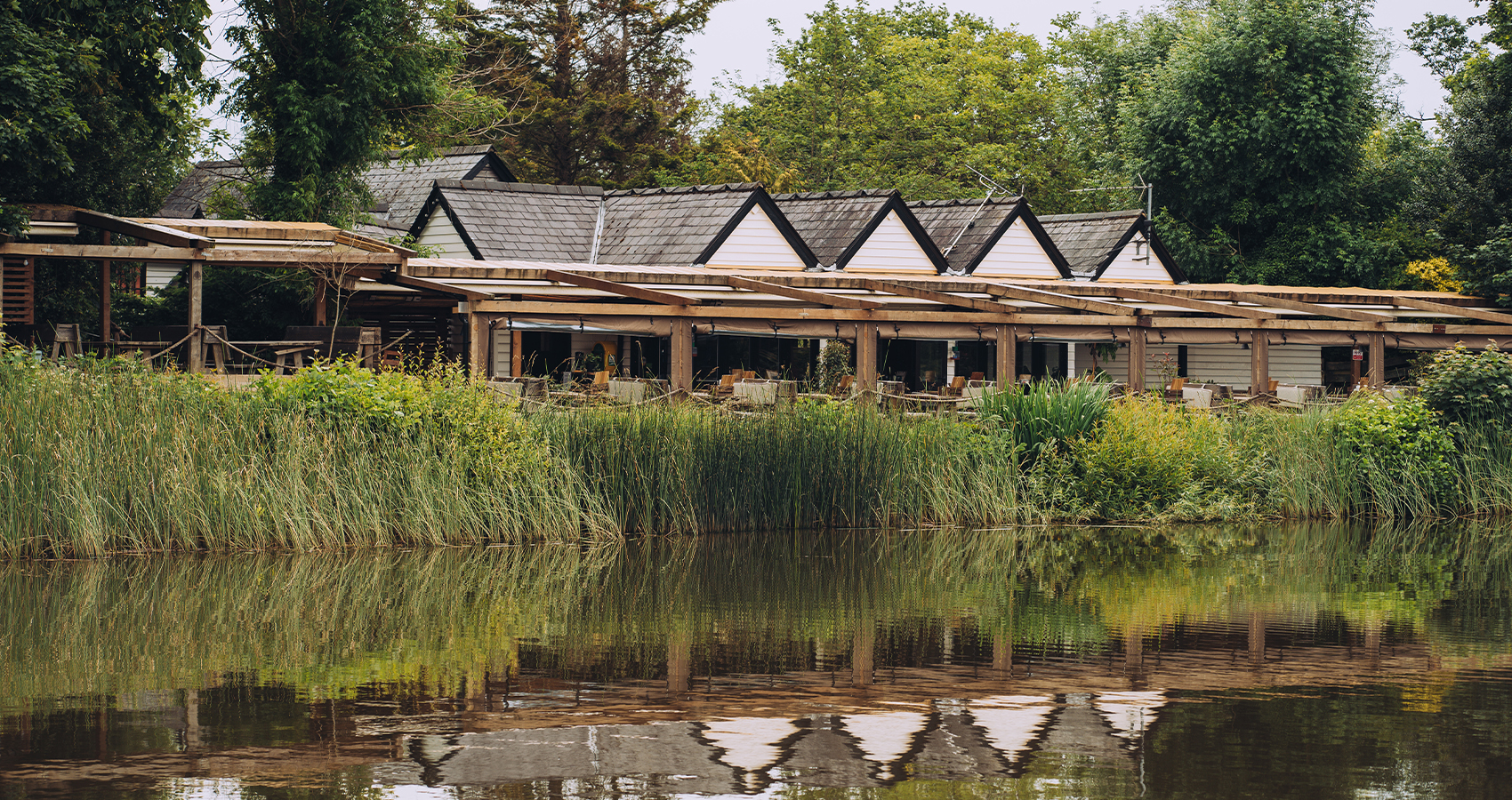 The Wiremill, Hall and Woodhouse pub situated on the side of a peaceful lake