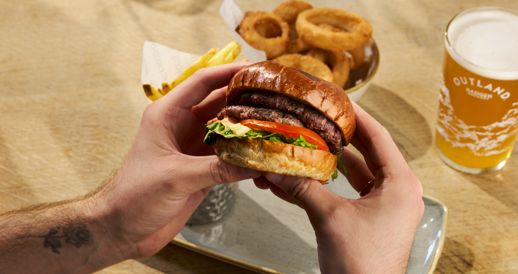 Hall and Woodhouse burger, onion rings and Outland beer